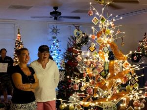 Members look at holiday tree